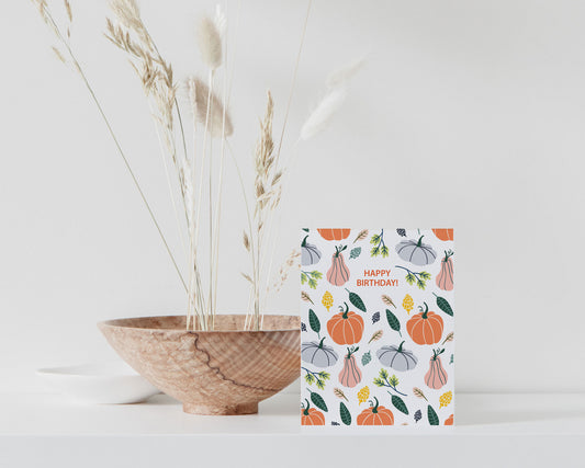 Preppy pastel pumpkin birthday card with cozy fall colors, folded with matching envelope.