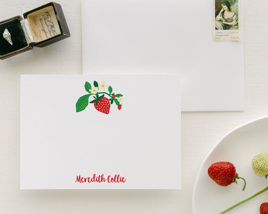 Flat personalized strawberry stationery with floral accents and custom name on bright white card stock.