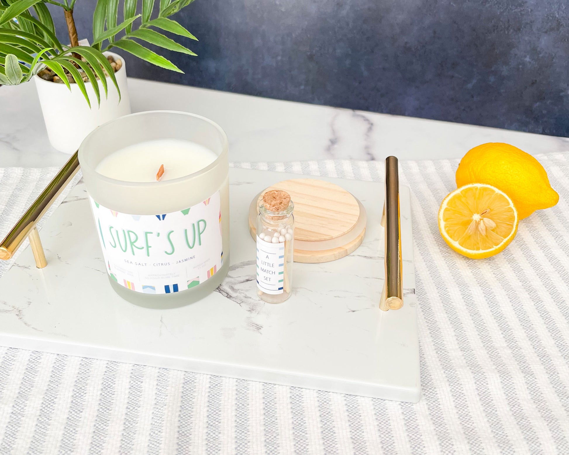 surfs up candle with match stick gift set, sea salt citrus jasmine scent, soy wax candle, set of ten matches in cork bottle, frosted candle vessel with wood lid, Meredith Collie paper